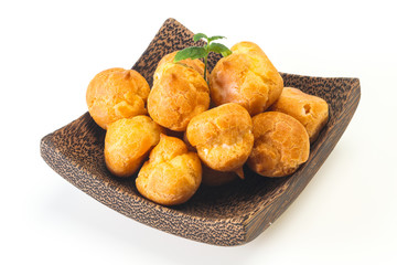 Sweet tasty profiteroles heap in the bowl