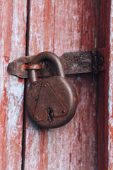 Old lock. Vintage padlock. Old rusty iron lock on a red background. Vintage Keyhole on elegant padlock.