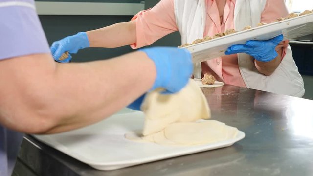Process of preparation delicious georgian khinkali. Food video. Close up. Female chiefs making dumplings. manual work concept. 4k