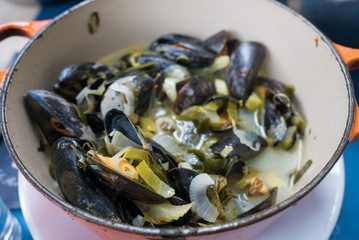 close up view of traditional mussel and french fries dish called 