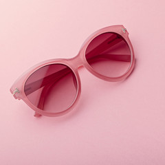 Classic oval oversized pink sunglasses closeup on pink background