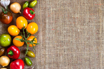 Assortment of colorful fresh vegetables on sackcloth background