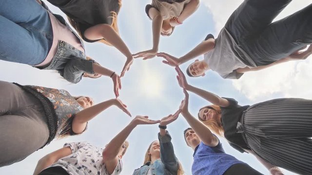Conceptual symbol of cooperation diverse hands making a circle.