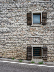 windows and doors of a building in a mountain village of Italy