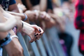 hands of fans waiting for a concert, hipsters, rock fans