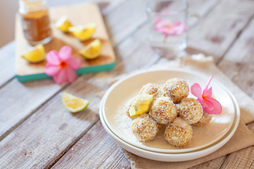 Healthy raw vegan candies with coconut and lemon, concept of tasty vegetarian food