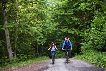 Young tourist couple travellers with electric scooters in nature.