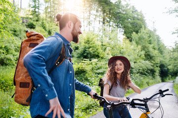 Young tourist couple travellers with electric scooters in nature.