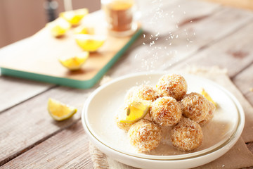 Healthy raw vegan candies with coconut and lemon, concept of tasty vegetarian food