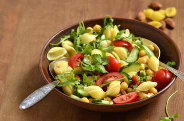 Mediterranean pasta salad with vegetables and chickpeas, copy space