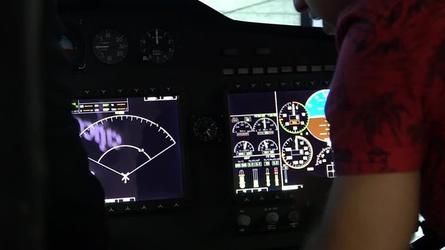 The blogger presses his finger on the dashboard of the helicopter