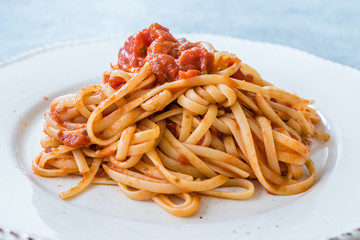 Heaped Plate of Classic Italian Pasta Spaghetti with Basil and Tomato Sauce.