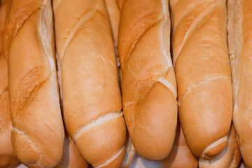 Long loafes in a show-window in a supermarket. Close-up