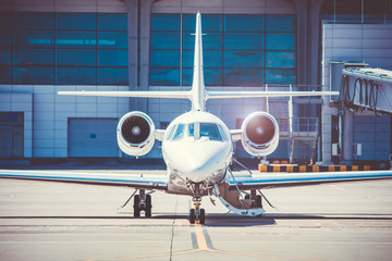 Luxury business jet standing at the airport. Luxury lifestyle and transportation by own airplane.