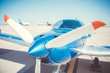 Little sport plane propeller. Little blue airplane in the airport.