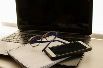 Workplace in the office, a break at work. Glasses for working behind the monitor. Near the keyboard...