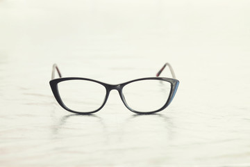 Fashionable stylish glasses on metalized background. Optics. Vision.