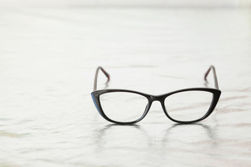 Fashionable stylish glasses on metalized background. Optics. Vision.
