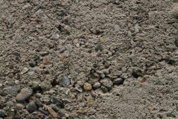 A detail of a solid, ferrous wall made of concrete. Concrete wall close up shoot.
