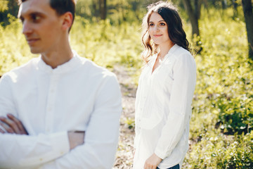 Fototapeta premium bright and happy pregnant woman walking in the park with her husband