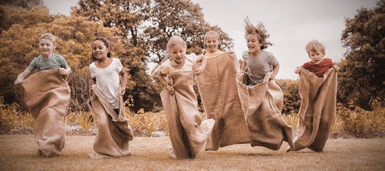 Children having a sack race in park