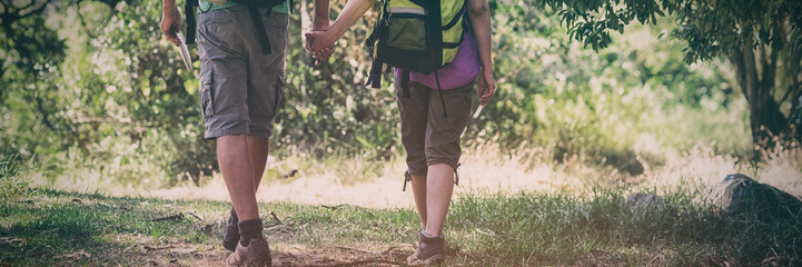 Couple hiking and holding hands each other