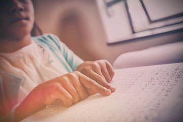 Girl using braille to read