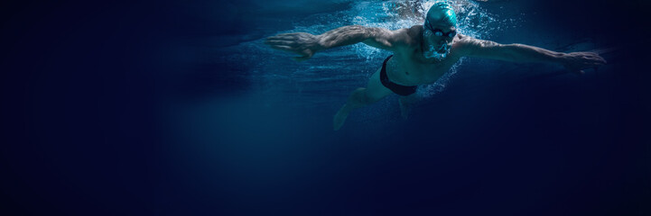 Fototapeta na wymiar Fit swimmer training by himself