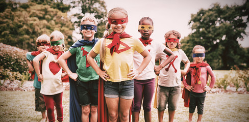 Children wearing superhero costume standing