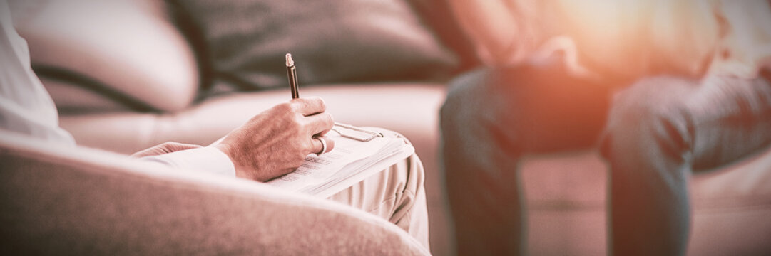 Therapist making notes of patient