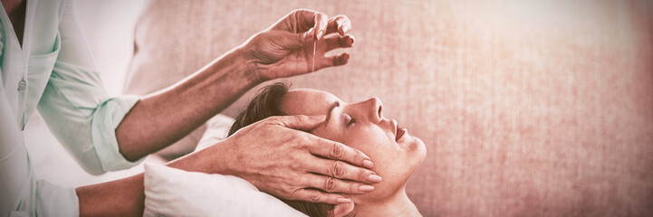 Woman receiving acupuncture treatment - obrazy, fototapety, plakaty