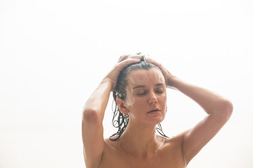 Obraz premium Young woman laying relaxing in bathtub. Woman taking a bath