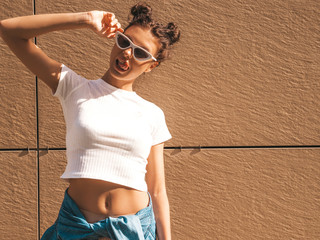 Beautiful smiling model with horns hairstyle dressed in summer hipster white t-shirt clothes.Sexy...