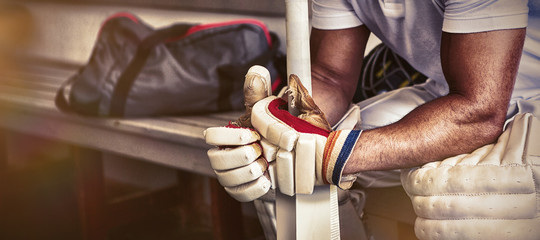 Stressed cricket player sitting on bench - Powered by Adobe