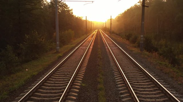 Slow motion of camera over flights going to the horizon where the sun rises
