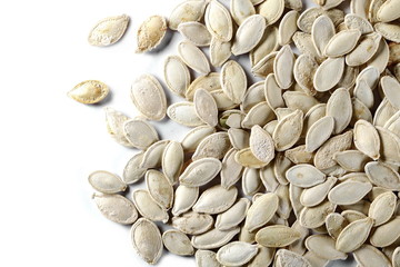 Salted pumpkin seeds isolated on white background, top view