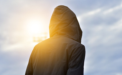 Runner man black hood coating sunlight sport exercise