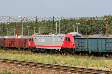 Fototapeta premium RAILWAY TRANSPORT - A modern locomotive pulls freight wagons