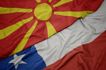 waving colorful flag of chile and national flag of macedonia.