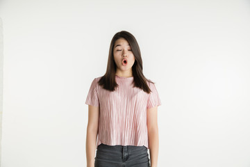Fototapeta premium Beautiful female half-length portrait isolated on white studio background. Young emotional woman in casual clothes. Human emotions, facial expression concept. Astonished, shocked, wondered.