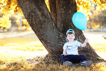 Little children are walking in autumn park