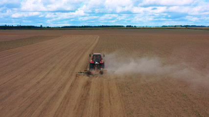 Aerial view drone of harvest field with tractor mows dry grass. Autumn yellow field with a haystack after harvest top view. Harves. Ting in the fields. Stock up