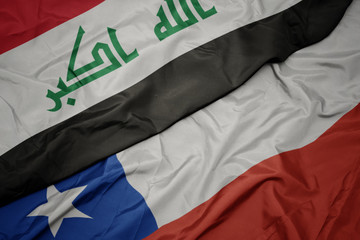 waving colorful flag of chile and national flag of iraq.