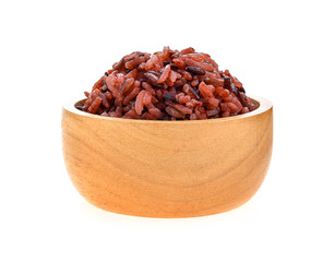 brown rice in wood bowl on white background