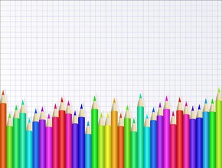 colorful crayons on checkered sheet of paper