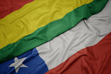 waving colorful flag of chile and national flag of bolivia.