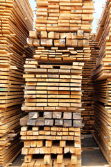 Wooden planks, lining, boards for construction works. Wooden planks for construction are sold in market. Vertical image.