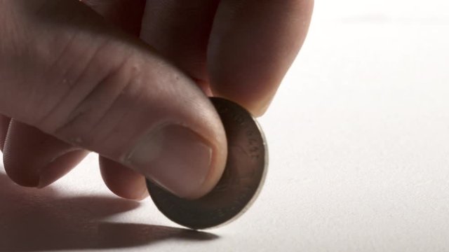 Hand holding 2 Deutsche Mark coin reverse side showing portrait of Kurt Schumacher. Official currency of Federal Republic of Germany.