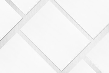 Close up of empty white rectangle poster or card mockups lying diagonally with soft shadow on...