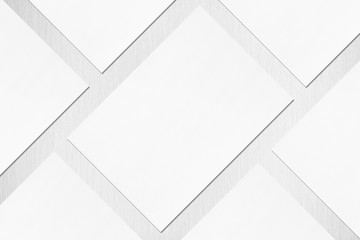 Close up of empty white rectangle poster or card mockups lying diagonally with soft shadow on...